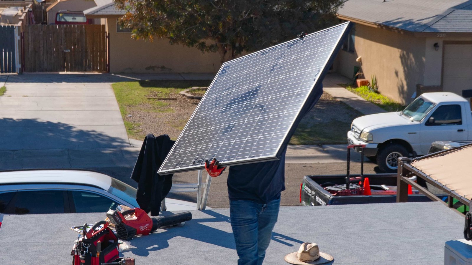 EcoEnergy technician lifting solar panel